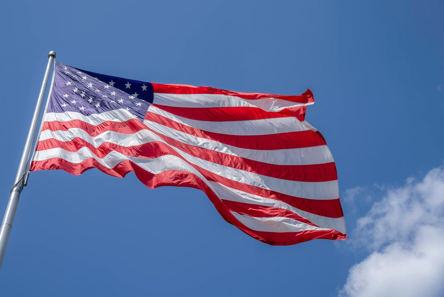 American flag waving against blue sky