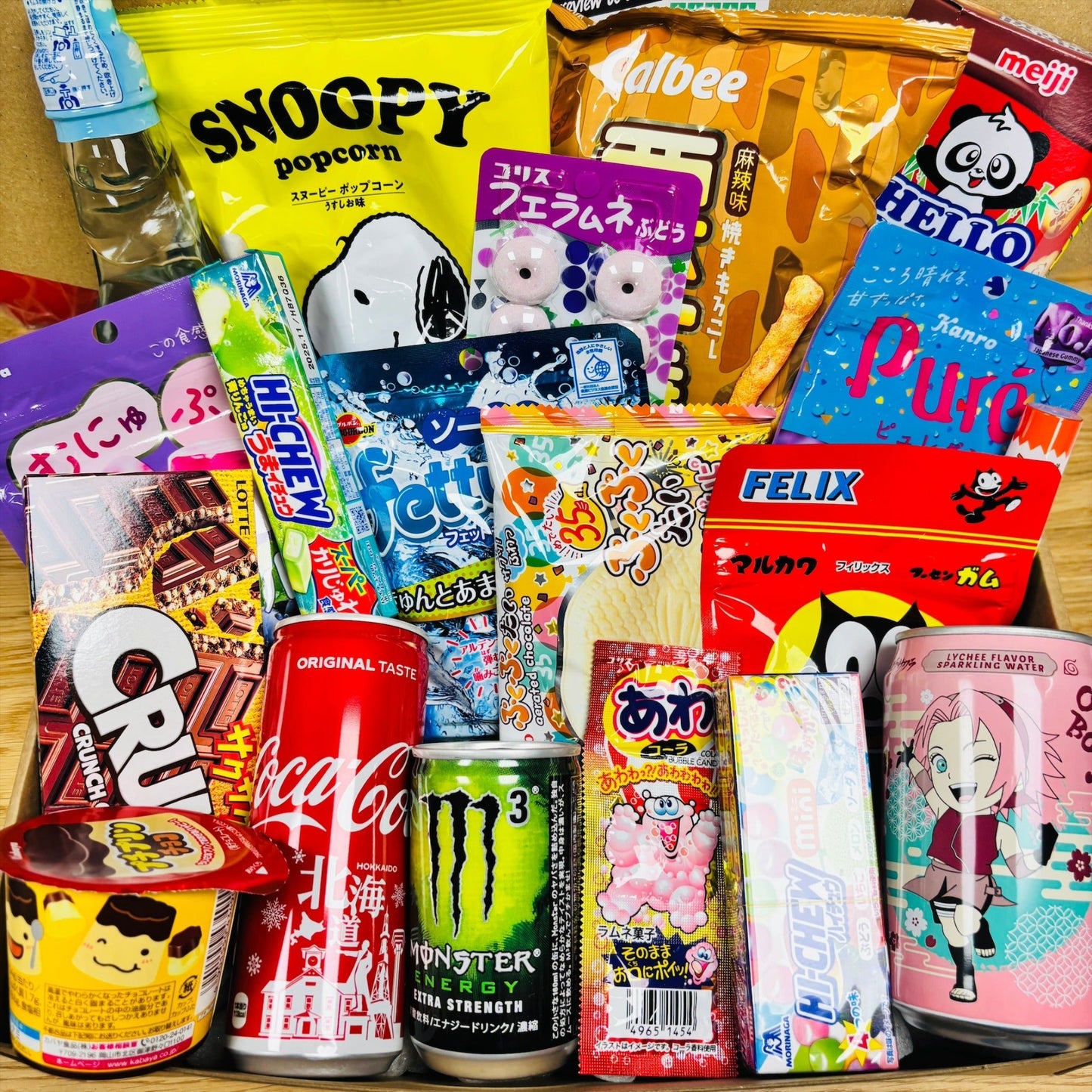 Assorted Japanese snacks and drinks box including sweets, popcorn and soda