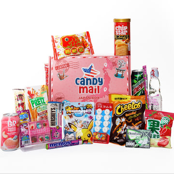 A Japanese candy and snack gift box set featuring a pink 'candy mail' box surrounded by popular snacks including Cheetos, Mentos, Pringles, and Brémoli on a plain white background.